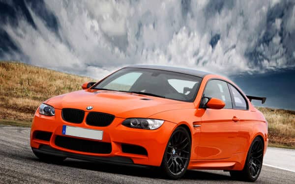 Bright orange BMW M3 E92 with dramatic sky. Car has Syvecs BMW E92 M3 - S7 PLUS kit fitted