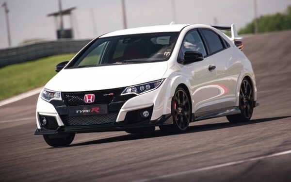 White Honda Civic type r car on a race track, front view with a Syvecs Civic Type R FK2 - S7PLUS ECU