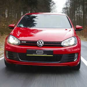 Front view of a gleaming red VW Golf speeding down a country road with Syvecs GOLF MK5 / MK6 TFSI / TSI - SGDI ECU