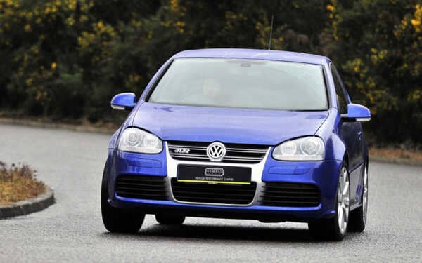 Front view of blue VW golf car driving in the rain with Syvecs GOLF R32 MK4 MK5 S7PLUS