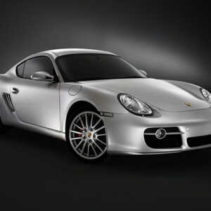 Silver Porsche Cayman shot in a dark black studio with amazing lighting. Car has Syvecs Porsche Cayman 987 / 981 - S7PLUS ECU