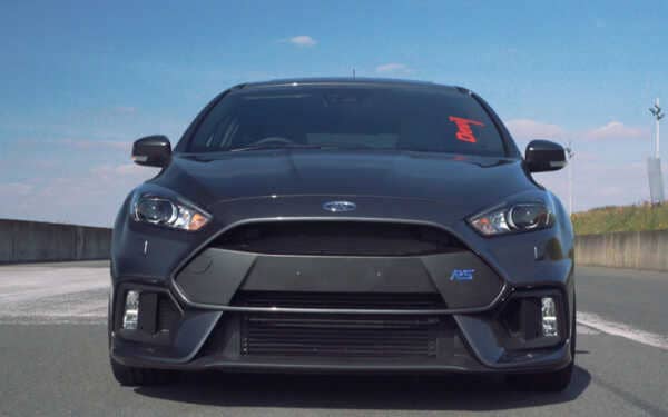 Front view of black ford focus car with blue sky. Running a Syvecs Ford Focus RS MK3 - SGDI4 ECU
