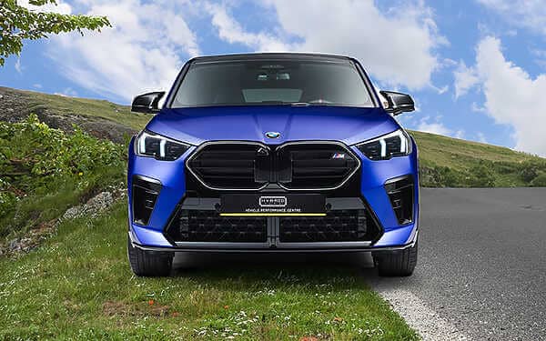 An exclusive, tailor-made offering for BMW F39 X2 M35i tuning. Front shot of a metallic blue BMW suv parked on a grass verge at the side of the road