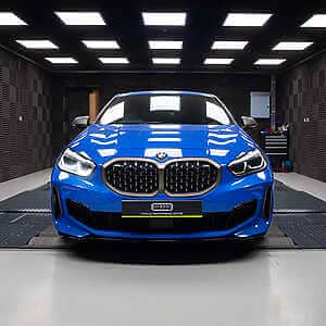 BMW F40 M135i F44 M235i F39 X2 Tuning B48TU Strat-2 Device 355 BHP : 497 NM. Blue F40 M135i front view in Hybrid tune's dark grey dyno cell