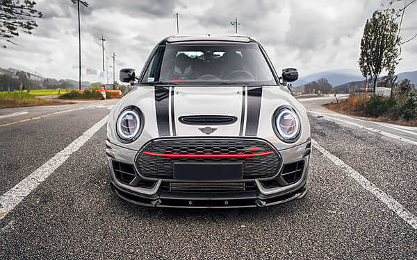 Mini F54 Clubman JCW Tuning B48TU STRAT-2 Device from Hybrid Tune. Front view of a grey mini with black bonnet stripes parked in the road with a moody sky in the background