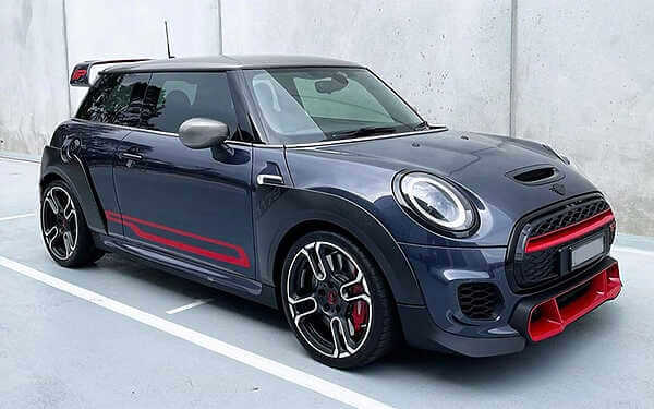 Mini F56 GP3 F54 Clubman JCW competitively priced B48TU tuning solution. Side shot of a beautiful grey mini f56 gp3 side on against a concrete background