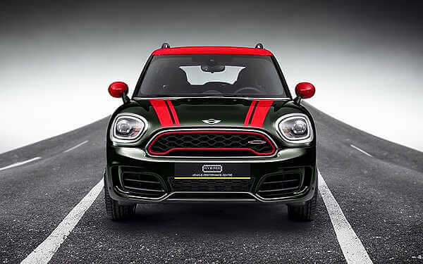 Mini F60 Countryman JCW tuning without the hassle of ECU removal. Front view of dark green mini countryman with red roof and bonnet stripes parked on a concrete road